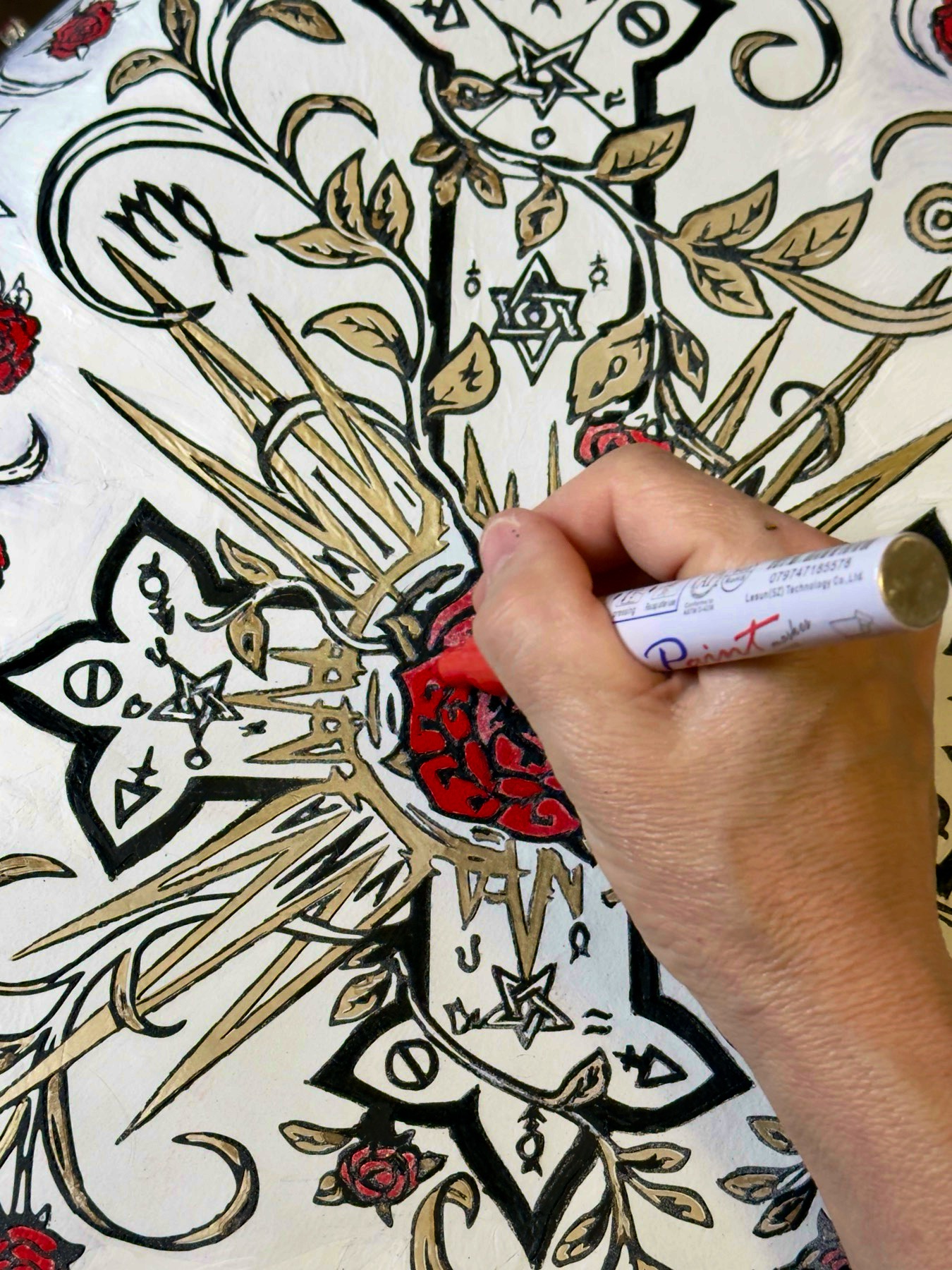 Painting-process detail — the central Rosy Cross motif being hand-painted