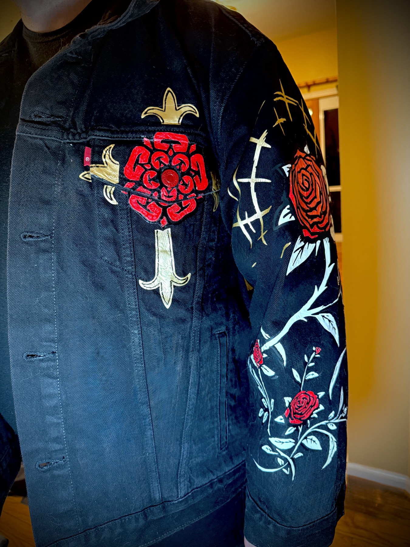 Pelican Battle Jacket — front chest detail, the rose-and-cross with a painted rose sleeve