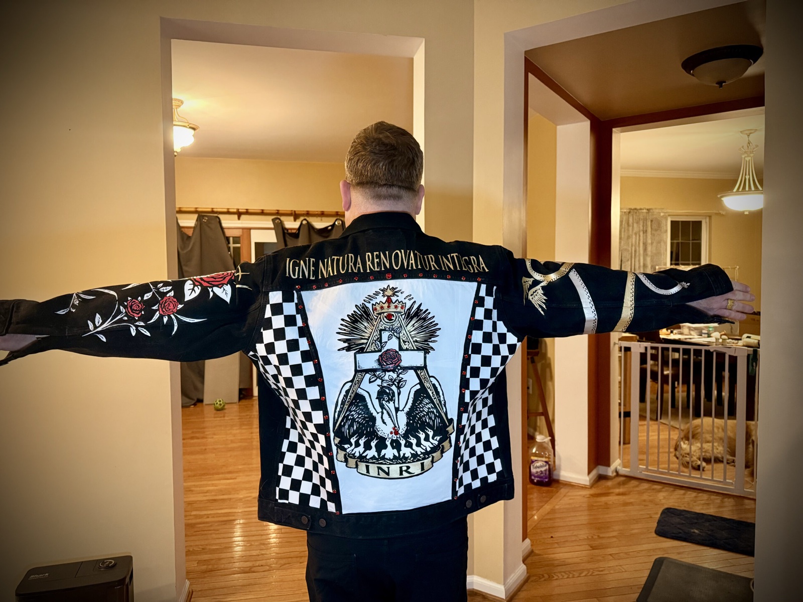 Pelican Battle Jacket — rear view, arms extended, showing the full back composition and both painted sleeves