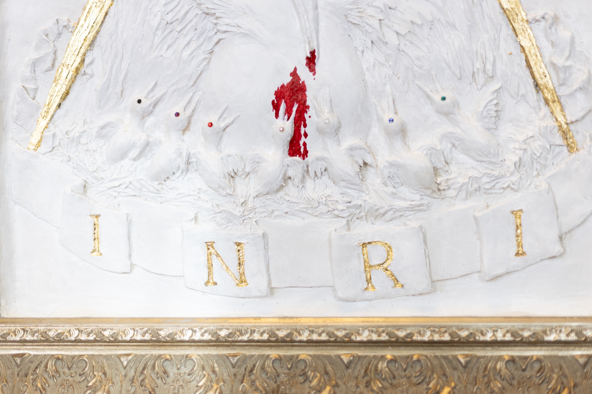 The Pelican in Her Piety — horizontal crop showing the full sculpted field